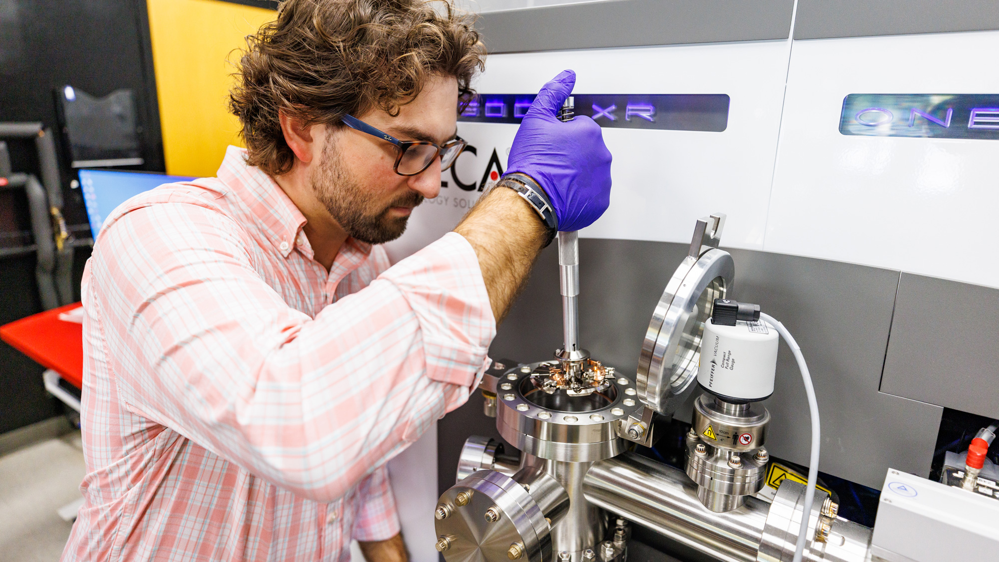researcher loading samples in the atom probe