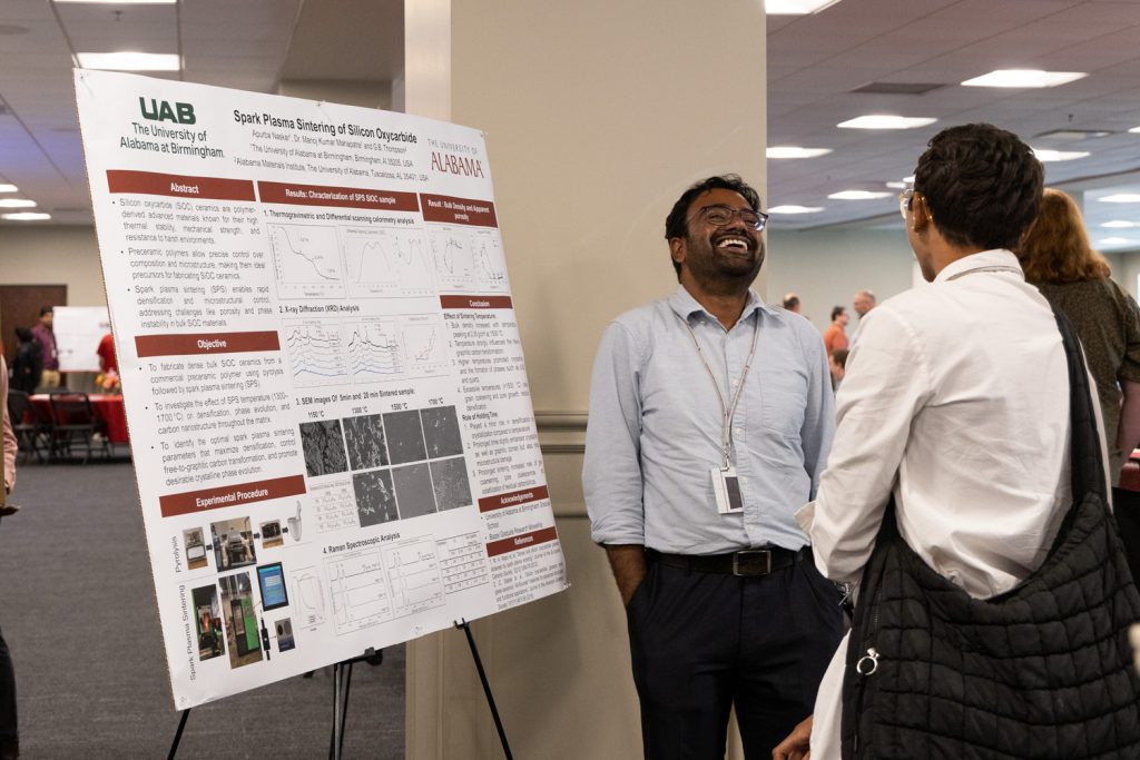 graduate student presenting poster at AMI Open HOuse